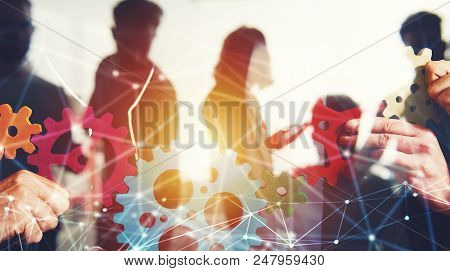 Teamwork Of Businesspeople Work Together And Combine Pieces Of Gears. Partnership And Integration Co