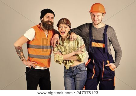 Building Brigade. Repair Brigade Concept. Teamwork, Full Service, Brigade. Man And Woman With Smilin