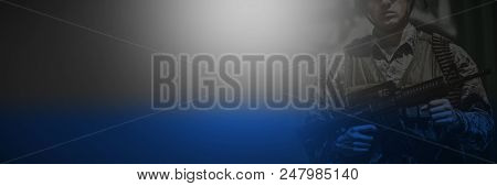 Portrait of military soldier standing with rile in boot camp