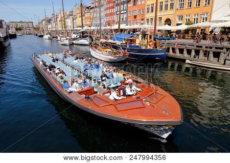 Copenhagen, Denmark - June 27, 2018: A N Open Top Sigthseeing Boat With Tourists In Nyhavn Old Port 