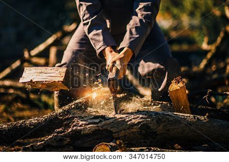Man Holding An Industrial Ax. Ax In Hand. A Strong Man Holds An Ax In His Hands Against The Backgrou