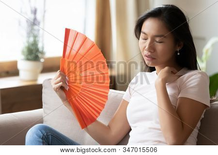 Unhealthy Young Asian Woman Breathe Fresh Air From Waver