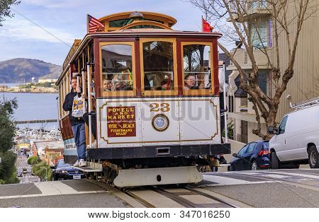 San Francisco, Usa - January 21, 2020: Tourists Riding The Iconic Cable Car At The Top Of Hyde Stree