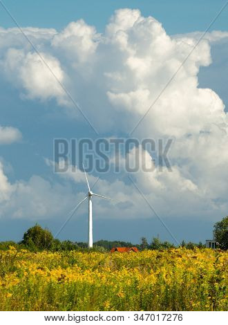 Wind Turbine Farm At The Field With Stormy Clouds. Wind Power For Electricity, Clean Energy. Baltic 