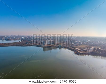 Aerial Landscape Photo Of Morii Lake , Bucharest, Romania With Many Buildings In The Distance.
