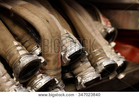 Fire Hoses For High Pressure Water Supply With Quick Connecting Locks Are Stacked On Top Of Each Oth