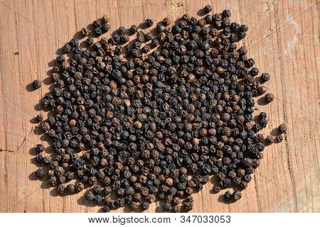 Black Peppercorns (kali Mirch) On Wooden Background