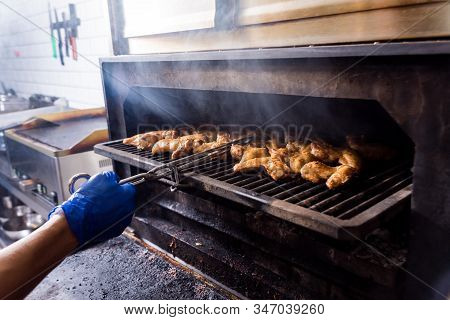 Fried Chiken Wings At Grill Barbecue. Restaurant.