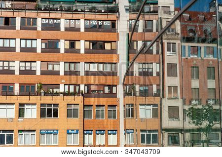Coloured Building Reflected On The Wall Of Another Building In Plaza Bizkaia. Bilbao