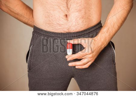 Man Taking Pill, Capsule In Male Hands Close Up. Muscular Guy With Naked Torso, Concept Of Viagra, M