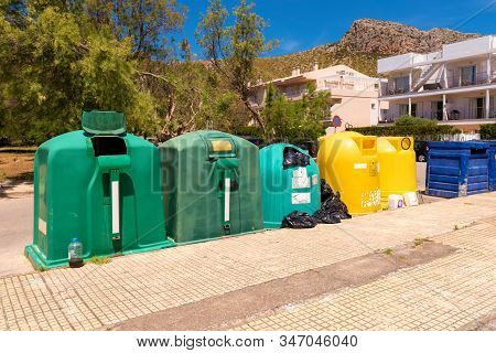 A Row Of Colorful Dustbins For Waste Segregation.