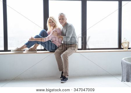 Beautiful Gladsome Couple Near The Window Stock Photo