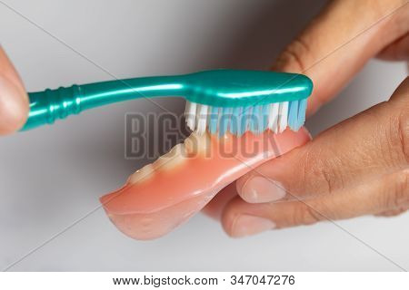 Cleaning Dental Prothesis With Toothbrush