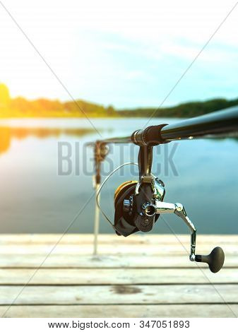 Carp Fishing On Beautiful Blue Lake With Carp Rods And Rod Pods In The Summer Morning. Fishing From 