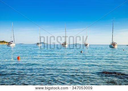 Anchored Sailing Boats And Yachts In Kosirina Bay On Murter Island In Croatia, Beautiful Touristic D