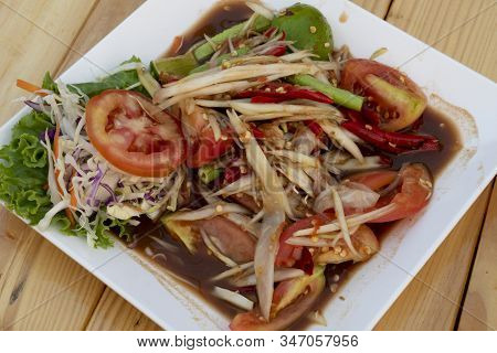 Papaya Salad With Fermented Fish And Thailand Name Som Tam Pa Ra In A White Dish Placed On A Wooden 