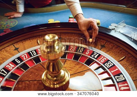 Hand Of A Croupier On A Roulette Whell In A Casino.