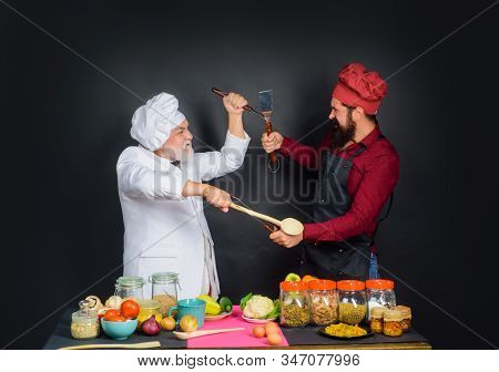Chef. Two Chefs Fighting On Kitchen. Professional Culinary. Bearded Man In Kitchen Apron. Bearded Ma