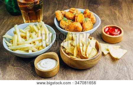 Table Fof Tasty Snacks And Beer Prepared For Watching Sports On Tv. Selective Focus