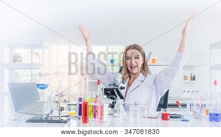 Pretty Scientist Work Reserching And Cheerfully In Chemical Laboratory, Science And Healthy Or Medic