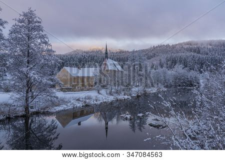 Blue Cloudy Morning With Fog And Church In Loucovice Village