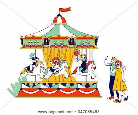 Children Riding Merry-go-round Entertainment Carousel In Recreation Park. Parents Making Photo Pictu