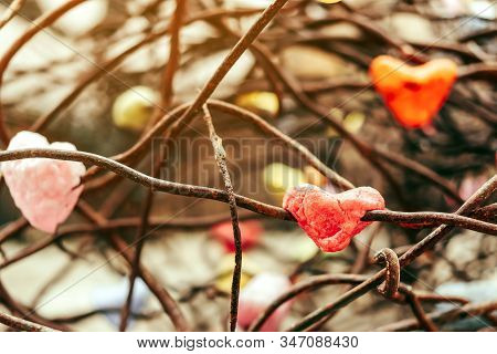 A Chunk Of A Red Heart Shaped Candle Adheres To An Old Rusted Steel Rod.  A Valentine's Day Backgrou