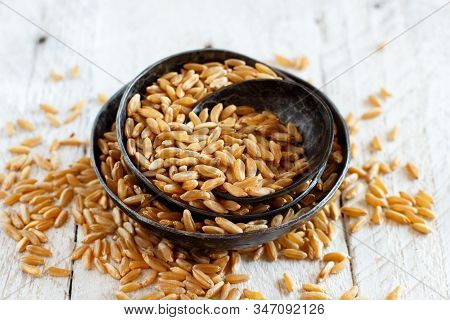 Raw Kamut Grain In A Wooden Bowl With A Spoon