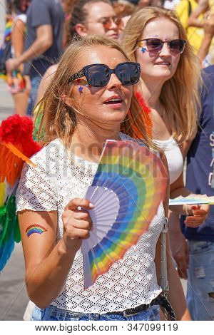The Annual Parade Lgbt. Lesbians Walking In The Gay Pride Parade. Parade Of Tolerance. Rainbow Flags
