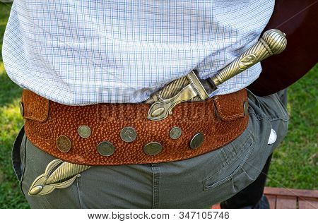 Areco, Argentina - January 22,2018: Detail Of The Traditional Belt And Knife Of A Gaucho In A Countr