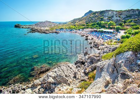 View Of Ladiko Beach With Sun Beds And Sun Shades (rhodes, Greece)