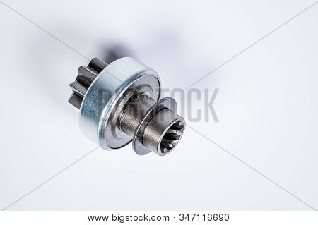 New Spare Parts - Starter Gear Drive For Motor Starter On A Gray Background. Classic Gear Transmissi
