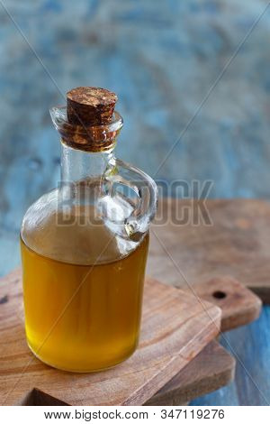 Olive Oil In A Bottle On A Blue Wooden Background