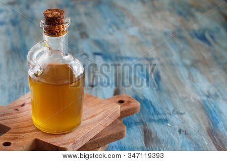 Olive Oil In A Bottle On A Blue Wooden Background
