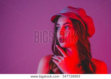 Profile. Girl In Profile Biret Looks Into The Distance Color Filter Pink Background. Brunette In A H