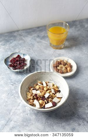 Bowl Of Granola With Nuts, Cranberry And Cocoanut. Concept For A Tasty And Healthy Meal. Stone / Woo