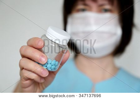 Doctor Giving Pills, Woman In Medical Mask With Bottle Of Blue Tablets. Concept Of Dose Of Drugs, Vi