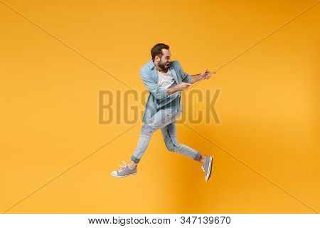 Funny Young Bearded Man In Casual Blue Shirt Posing Isolated On Yellow Orange Background, Studio Por