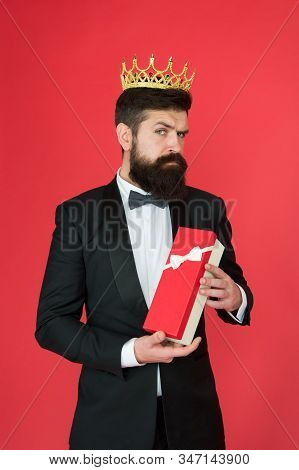 Being Complete Egoist. Egoist Hold Present Box Red Background. Bearded Man Wear Crown. Egoist Or Big