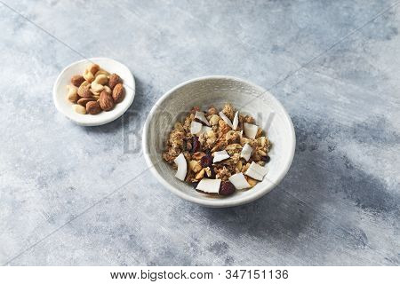 Bowl Of Granola With Nuts, Cranberry And Cocoanut. Concept For A Tasty And Healthy Meal. Stone Backg