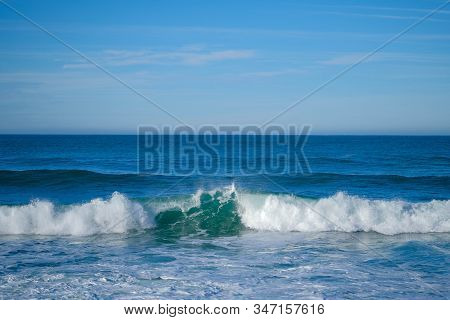 Large Ocean Waves On A Clear Sunny Day On The European Coast. Winter Holidays On The Atlantic Ocean.