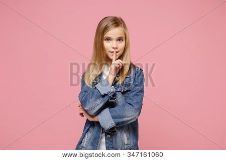 Secret Little Kid Girl 12-13 Years Old In Denim Jacket Isolated On Pastel Pink Background In Studio.
