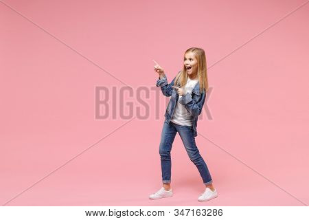 Cheerful Little Blonde Kid Girl 12-13 Years Old In Denim Jacket Isolated On Pastel Pink Background C