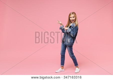 Excited Little Blonde Kid Girl 12-13 Years Old In Denim Jacket Isolated On Pastel Pink Background Ch