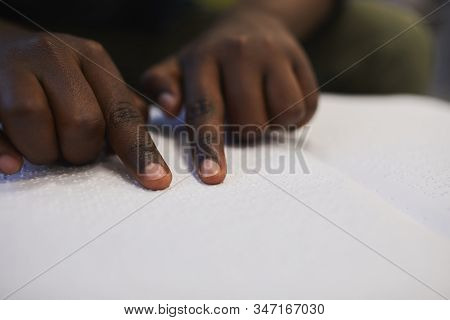 Closeup Of Unrecognizable Blind African Man Reading Braille Book While Studying In School, Copy Spac