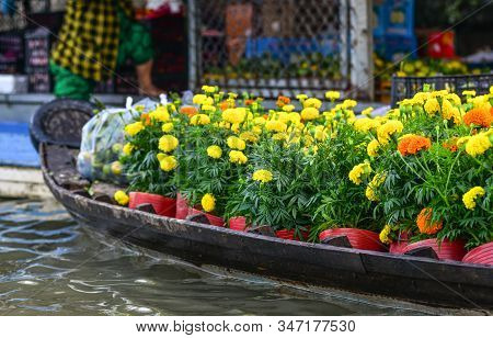 Wooden Boat Carrying Flowers At The Floating Market In Mekong Delta, Vietnam.