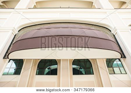 Brown awning Over Cafe Window. Cafe Tent. Canopy Sunshade for Store Window, Outdoor Market Awnings.