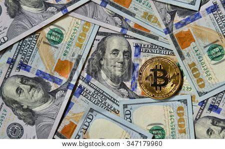 Golden Bitcoin On Usd 100 Billnote Dollar Background. Finance Concept.