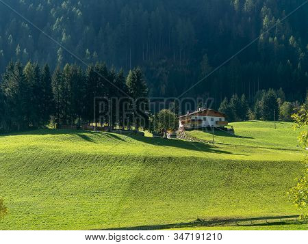 A Lonely House In The Dolomites Valley. Panoramic View, Autumn In Alto Adidge