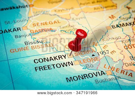Prague, Czech Republic - January 12, 2019: Red Thumbtack In A Map. Pushpin Pointing At Conakry City 